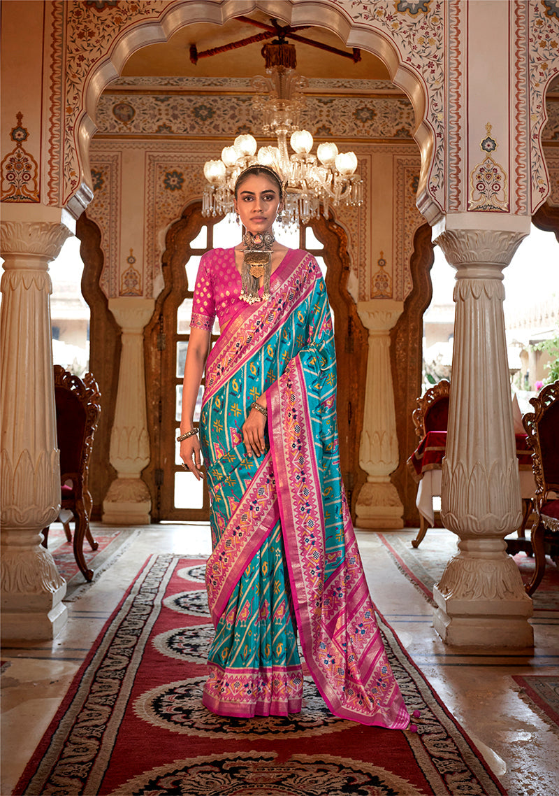 Aqua blue silk saree with Patola print patterns for festive styling.