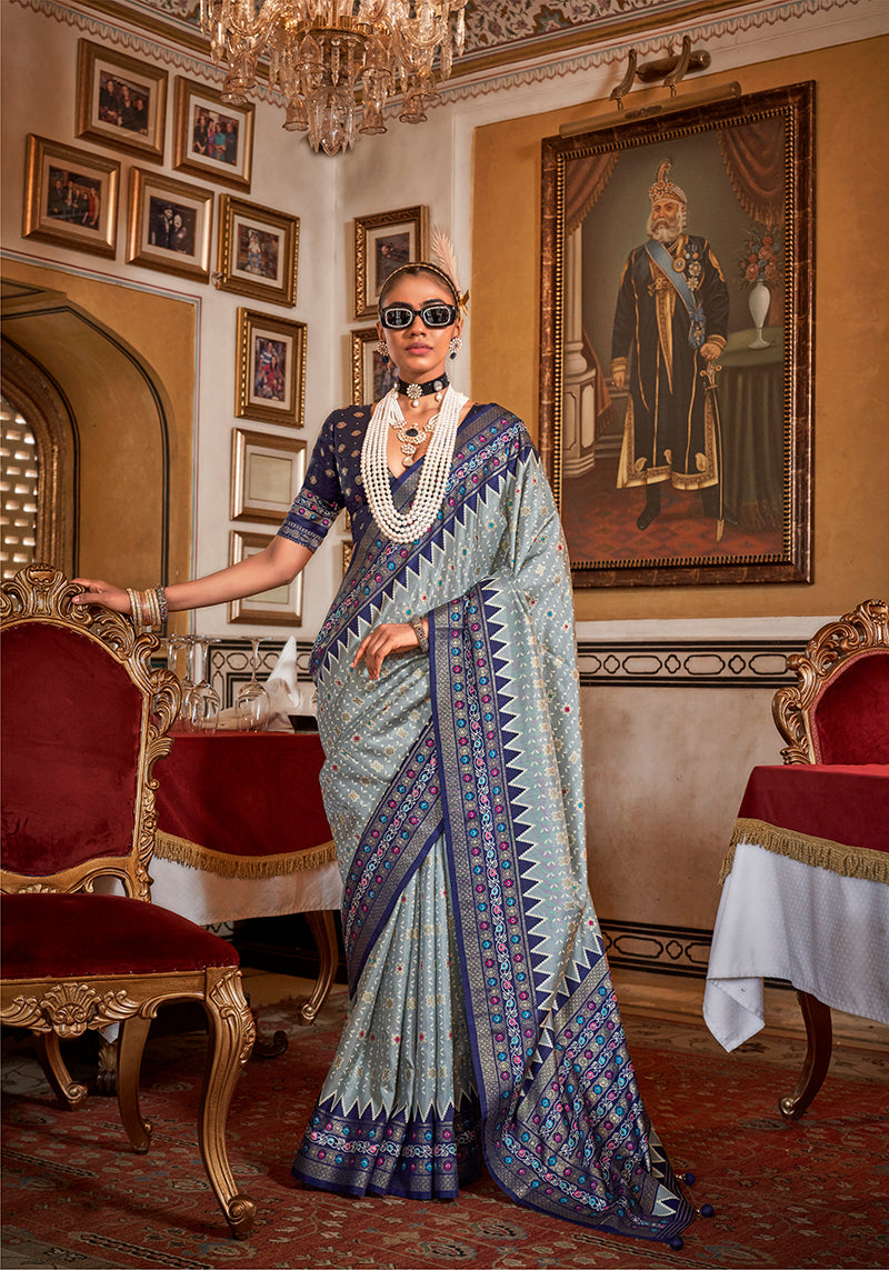 Light grey silk saree with navy blue border and print detail