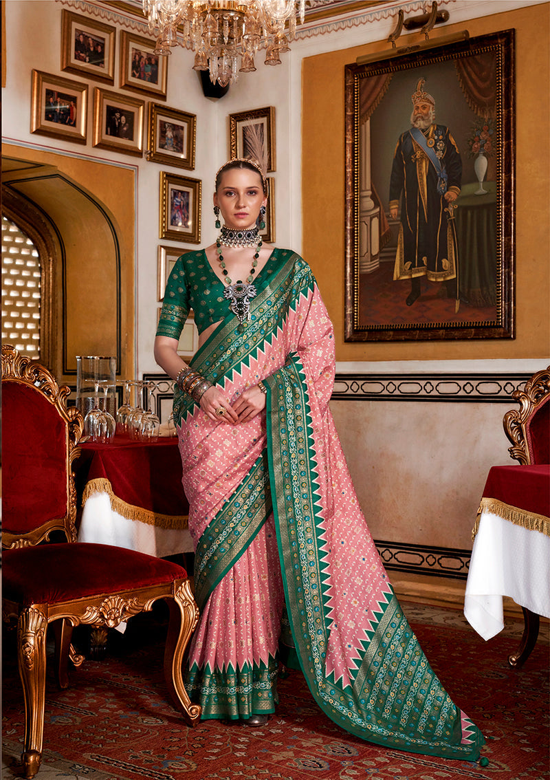 Light pink silk saree with a decorative green printed border.