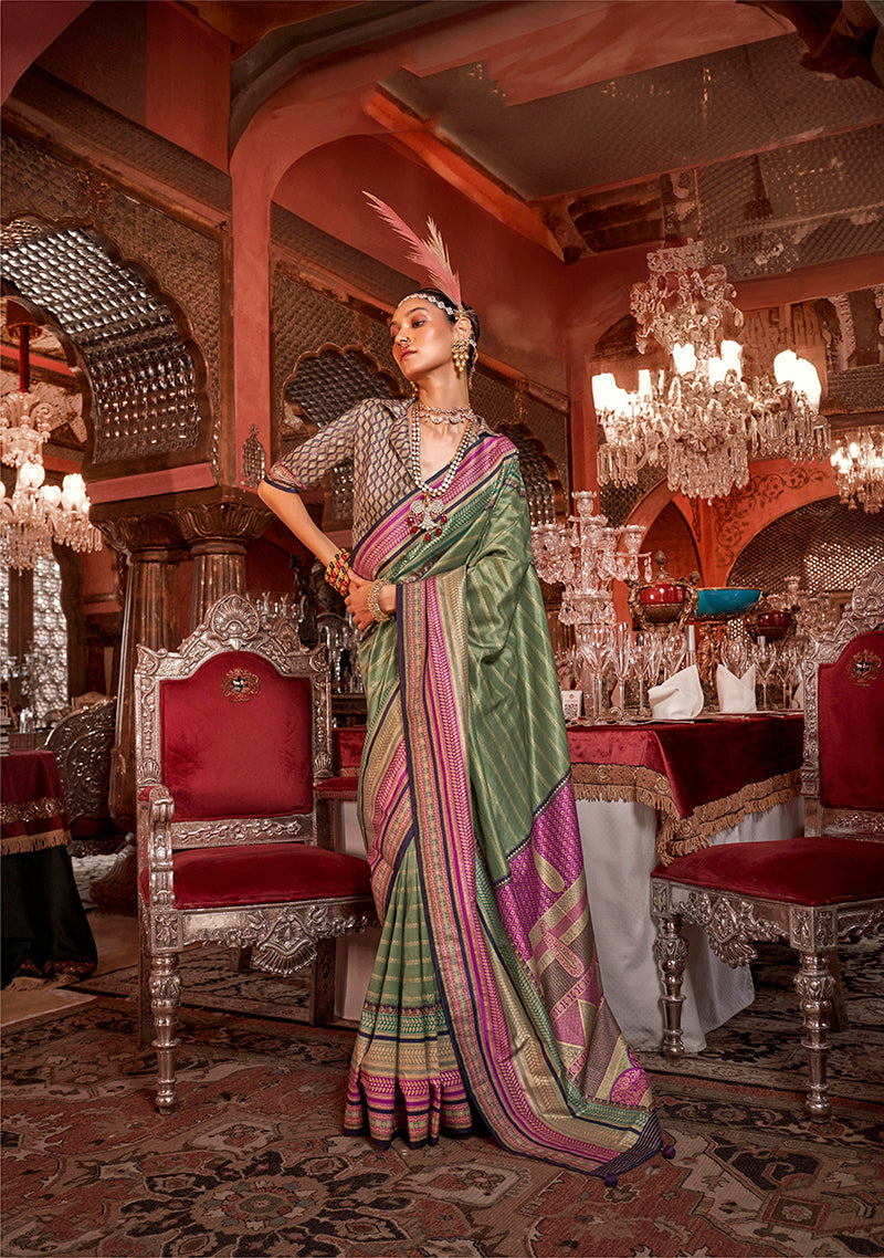 A traditional green silk saree with gold zari weaving patterns.