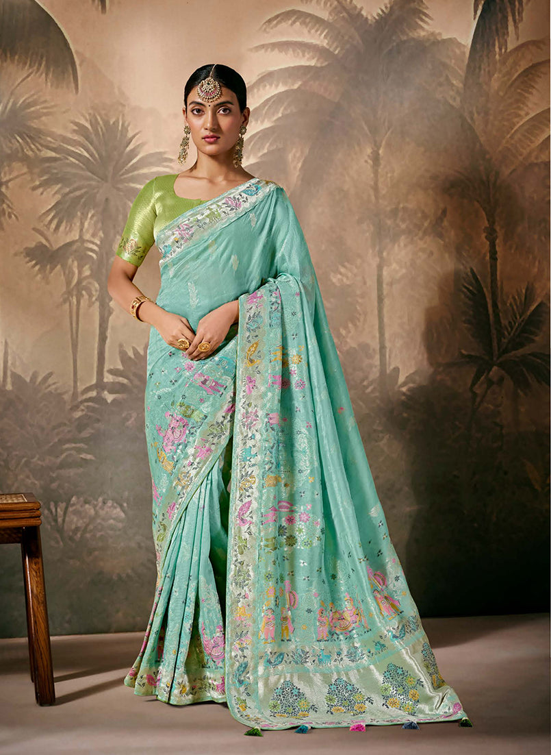 Aqua blue silk saree with floral prints and gold Zari work border.