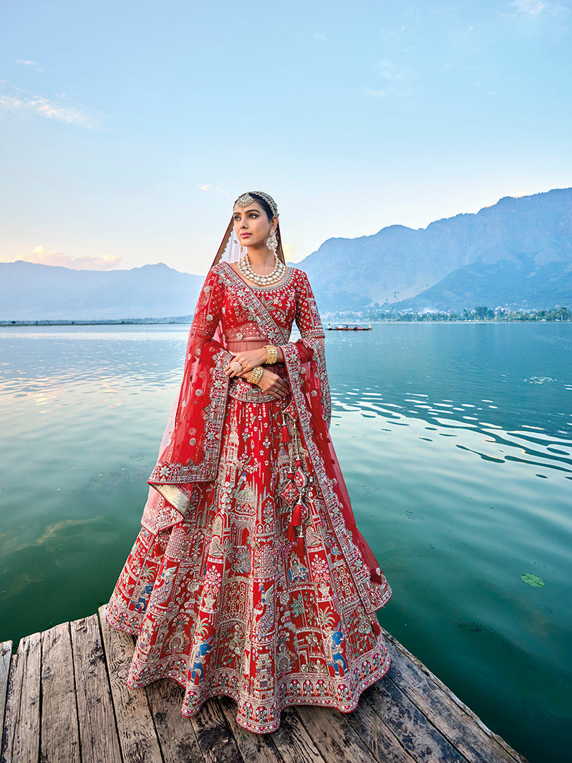 Traditional red silk bridal lehenga with Zari and sequin embroidery.