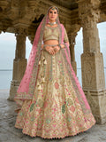 Cream silk bridal lehenga choli with heavy zari, thread work, and sequins embroidery.