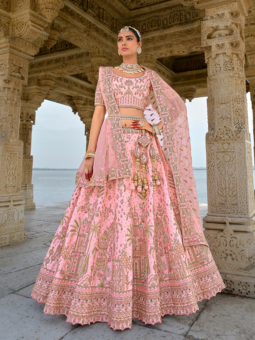Light pink bridal lehenga choli featuring intricate embroidery and sequin work.