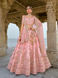 Light pink bridal lehenga choli featuring intricate embroidery and sequin work.