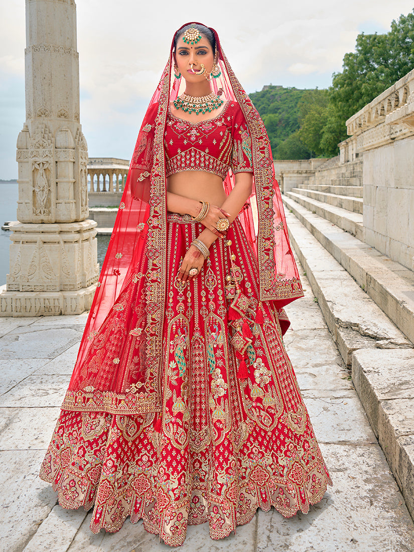 Elegant red silk bridal lehenga choli with detailed zari and sequin embroidery.