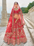 Elegant red silk bridal lehenga choli with detailed zari and sequin embroidery.