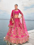 Luxury Rani Pink silk lehenga featuring detailed embroidery and Zari embellishments.