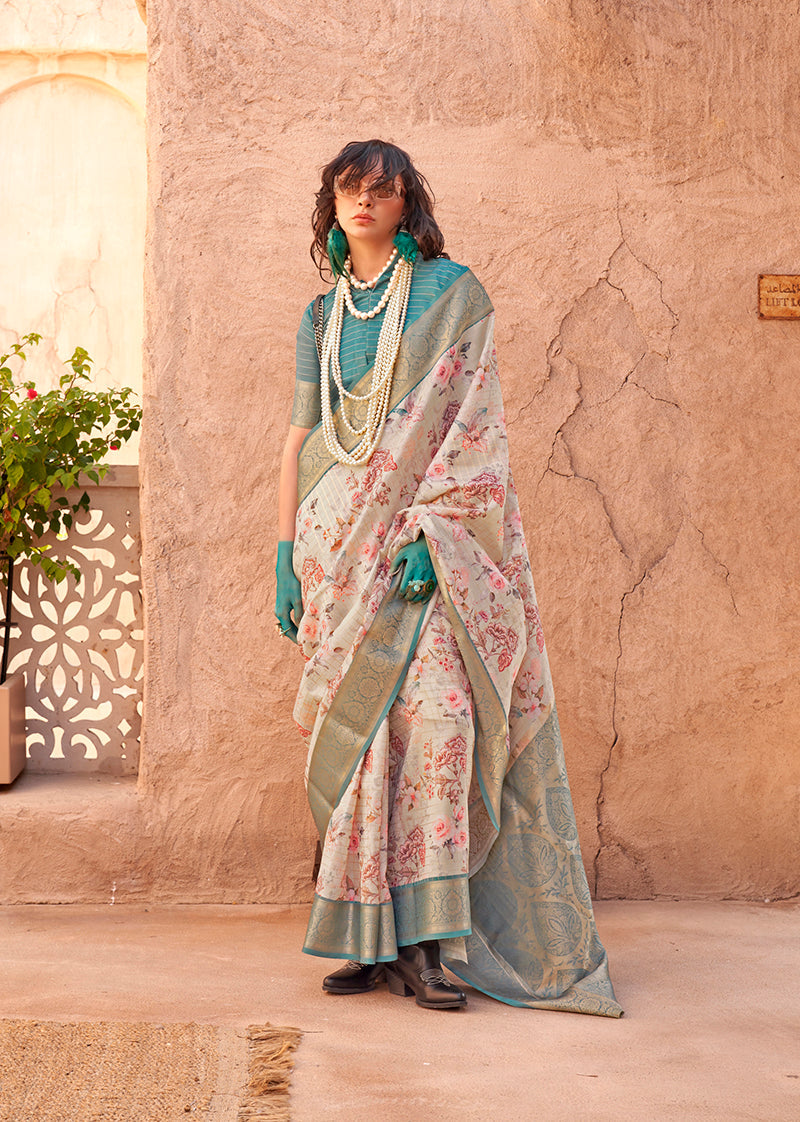 A cream georgette saree with digital prints and detailed ethnic weaving work on the border.