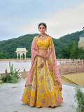 Yellow and pink silk blend designer lehenga choli with intricate sequins and embroidery.