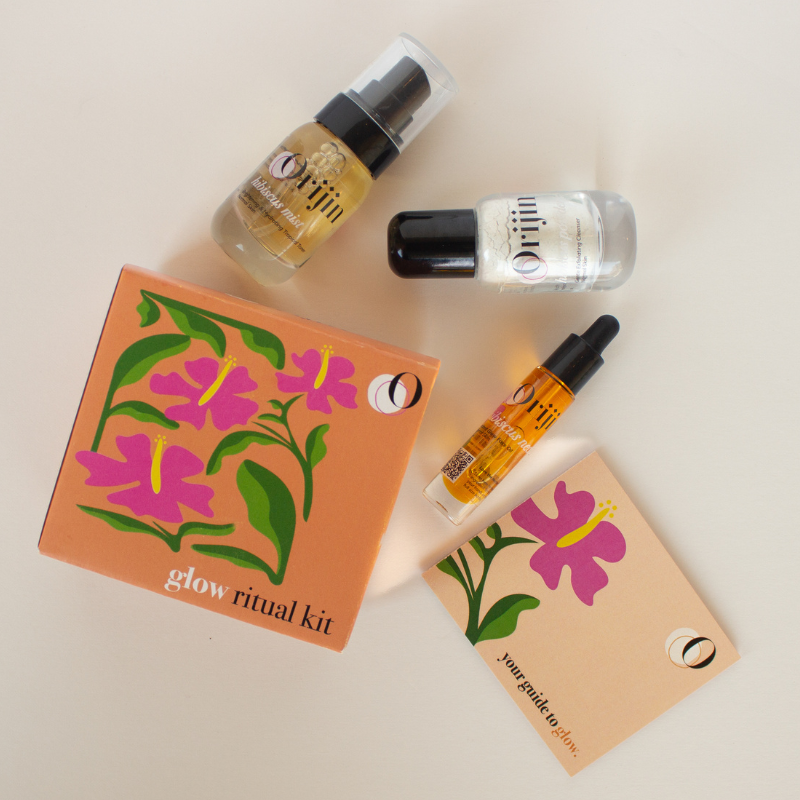 Orijin Glow Ritual discovery kit featuring hibiscus powder, hibiscus mist, and hibiscus nectar bottles next to a floral box.