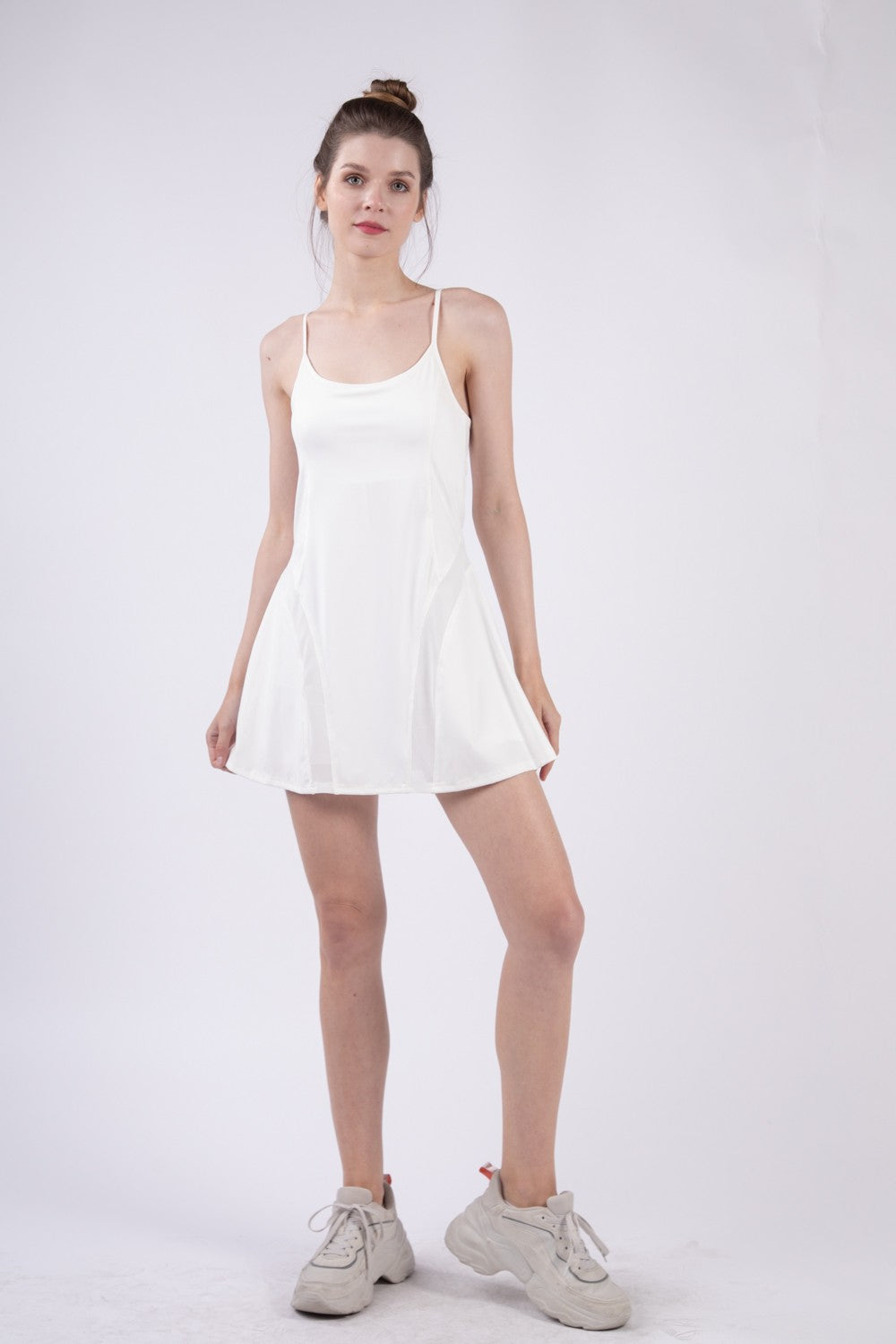 Stevvex Mesh Detail Tennis Mini Active Dress with built-in shorts in a sporty, breathable design.
