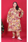 A woman wearing a maroon-based multicolor floral print co-ord set with a collared button-down top.