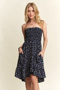 A floral print tube dress with a smocked bodice and pockets.