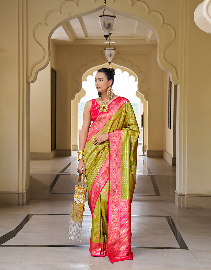 Close up of olive green and hot pink Banarasi silk saree with geometric woven details
