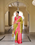 Close up of olive green and hot pink Banarasi silk saree with geometric woven details