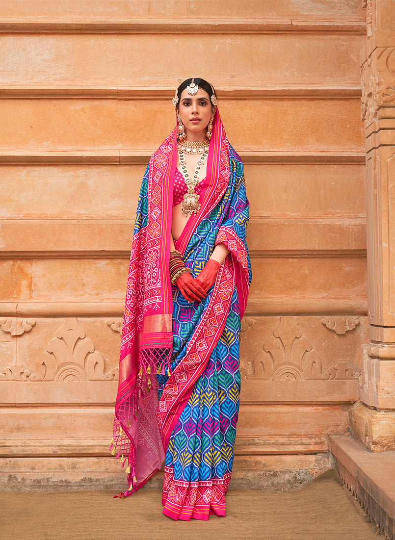 Blue silk saree featuring intricate patola prints, perfect for ceremonial events.