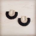 Pair of gold-tone hoop earrings with a semi-circular fan of black seed beads and small clear crystal accents on a light wood background.