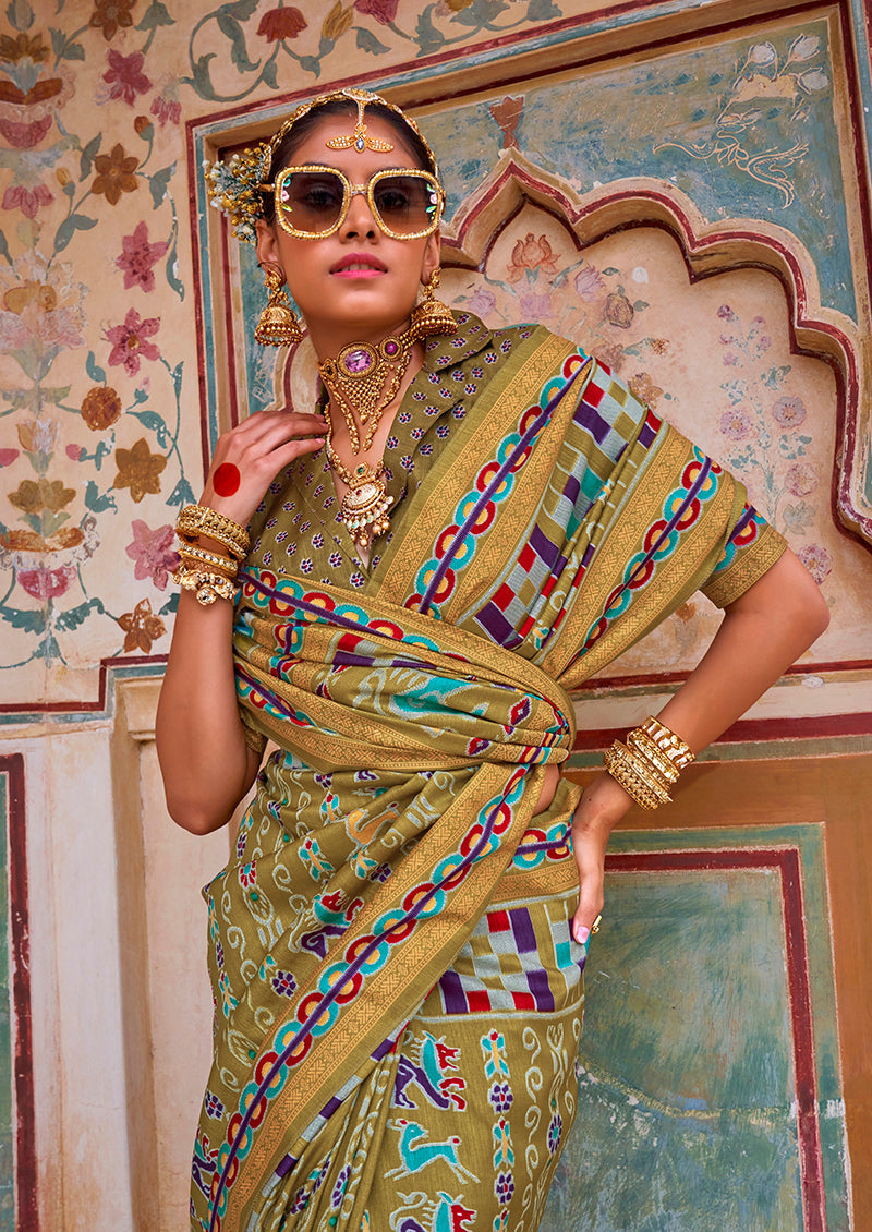 Elegant olive silk saree with vibrant traditional patola print patterns