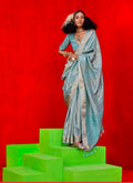 Light blue tissue saree with intricate zari work throughout the fabric.