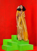 A rich mustard colored tissue saree detailed with fine gold zari weaving work.