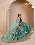Teal colored art silk designer lehenga choli with ornate traditional embroidery
