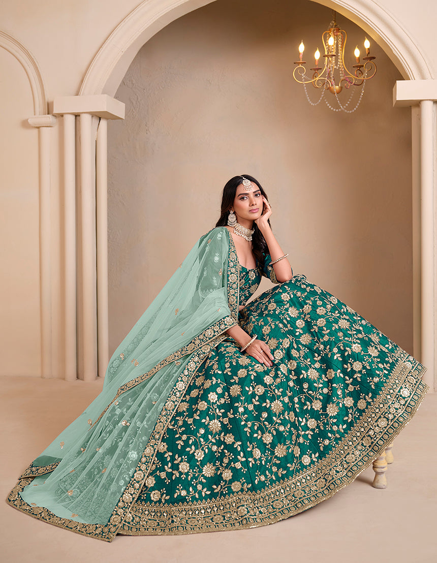 Teal colored art silk designer lehenga choli with ornate traditional embroidery