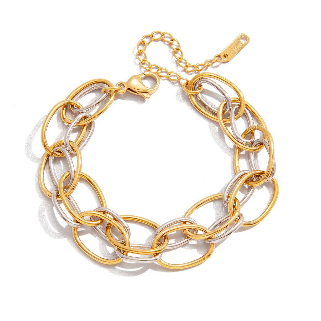 A luxurious two-tone titanium steel bracelet featuring 18K gold accents resting on a neutral background.