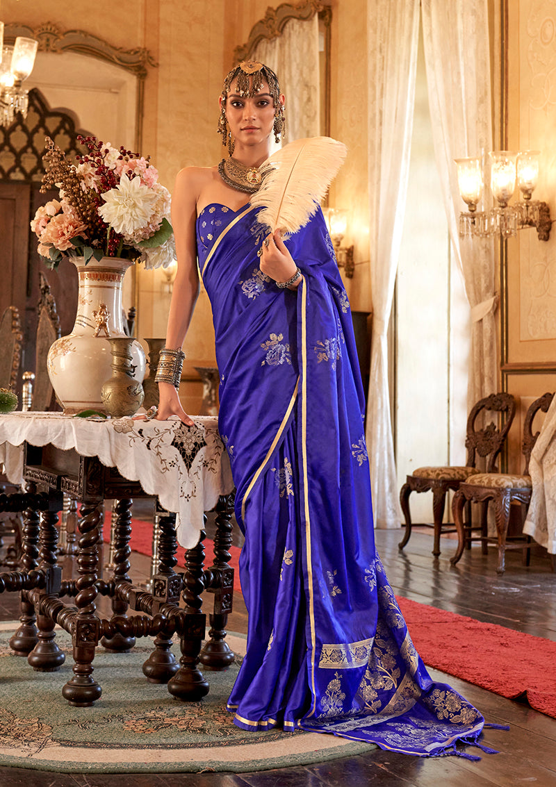 Luxurious Indigo satin silk saree with intricate weaving design draped elegantly.