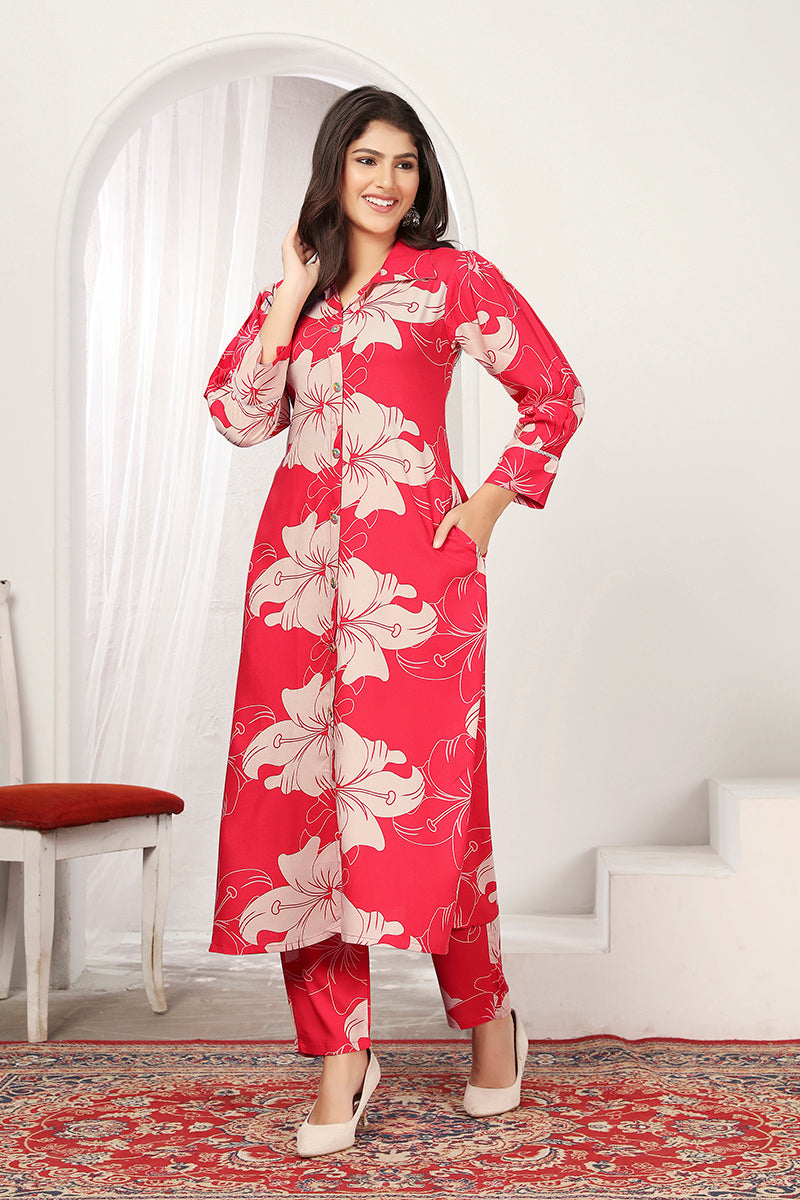 A woman wearing a stylish red rayon kurti and matching pants with an abstract floral print.