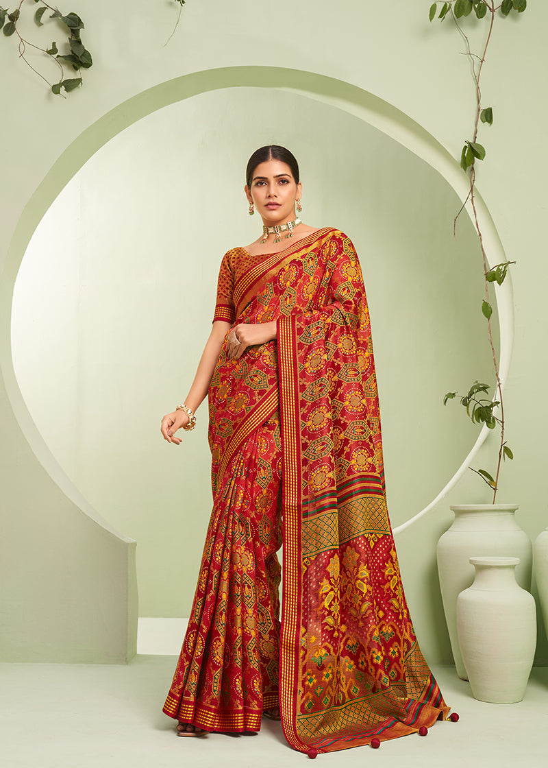 Model wearing a vibrant red ceremonial saree with paisley prints in georgette fabric.