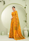 Amber color georgette saree featuring an intricate paisley print for ceremonial wear