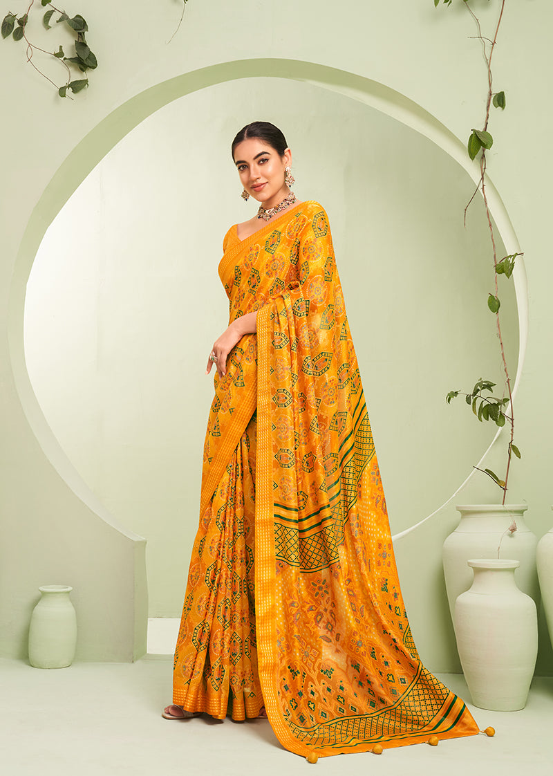 Amber color georgette saree featuring an intricate paisley print for ceremonial wear
