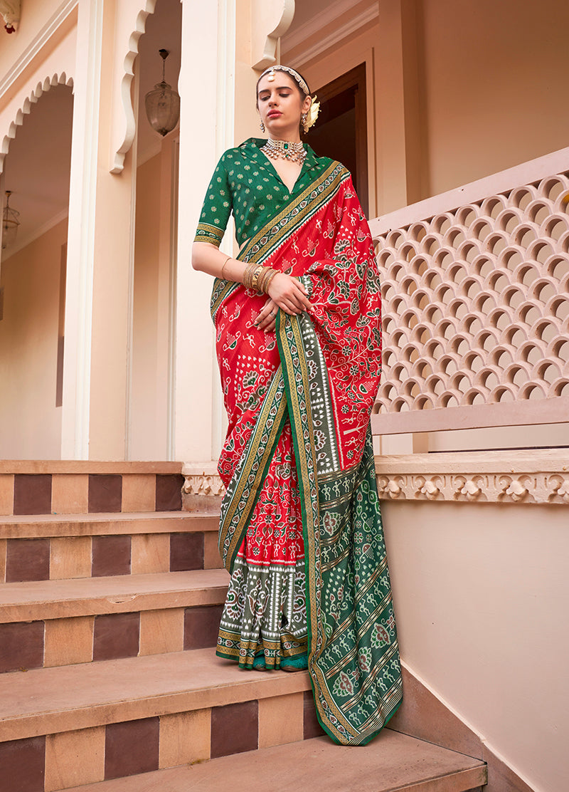 A classic red silk saree featuring vibrant prints, perfect for festive events.