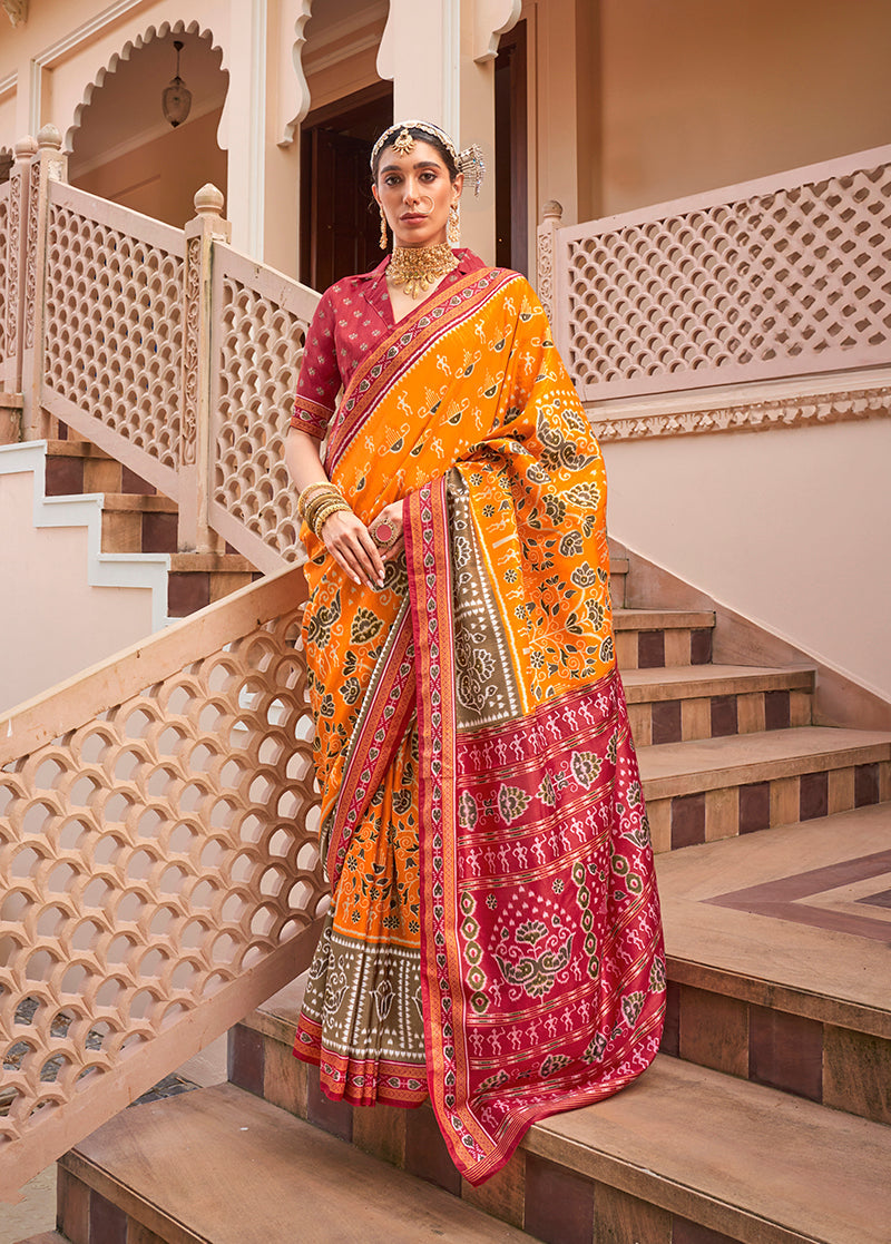 Woman wearing an amber and maroon printed silk traditional saree for formal occasions