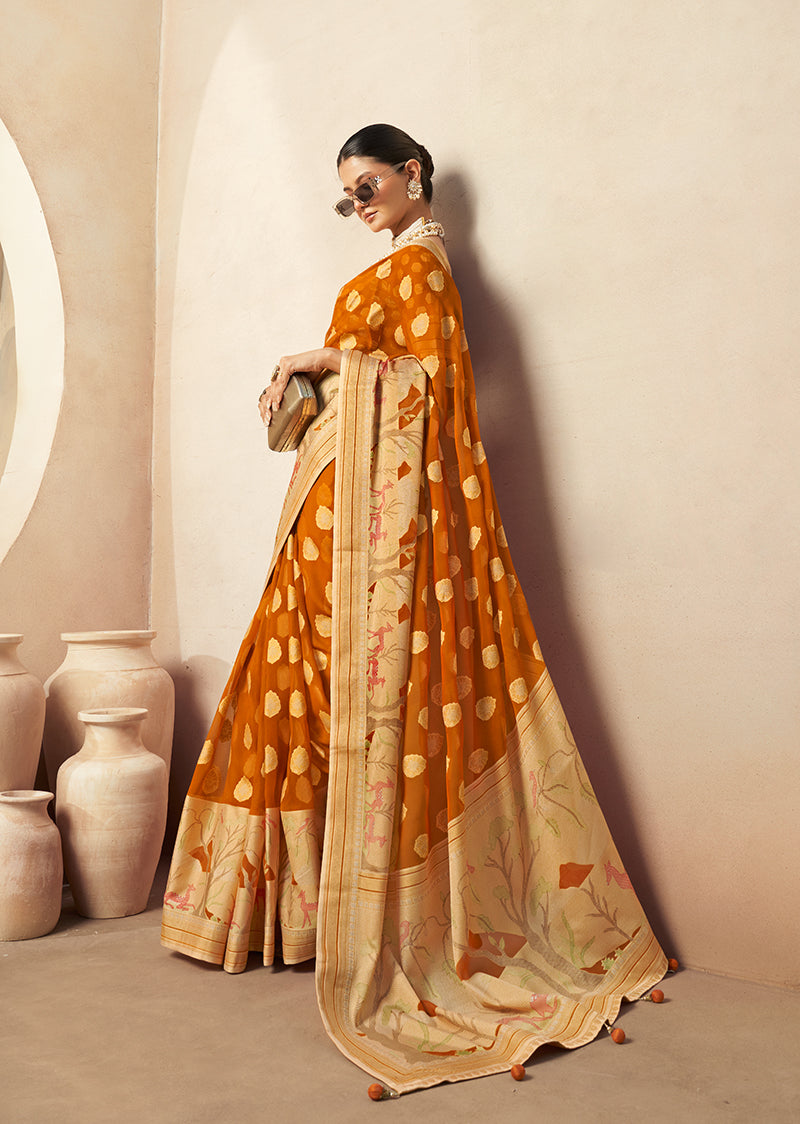 Vibrant orange georgette saree featuring intricate gold zari weaving patterns