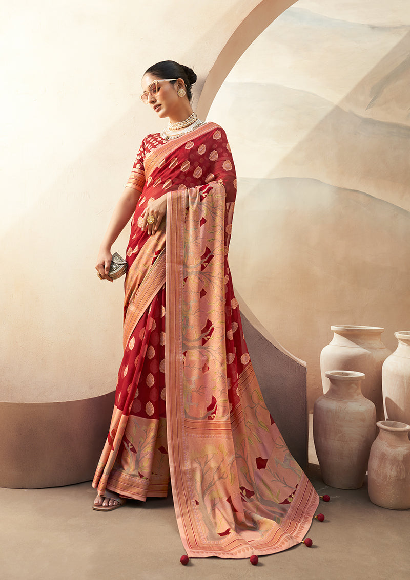 A red georgette saree featuring zari prints, suitable for festive occasions.