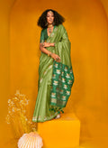 Green handloom silk saree featuring traditional zari weaving design