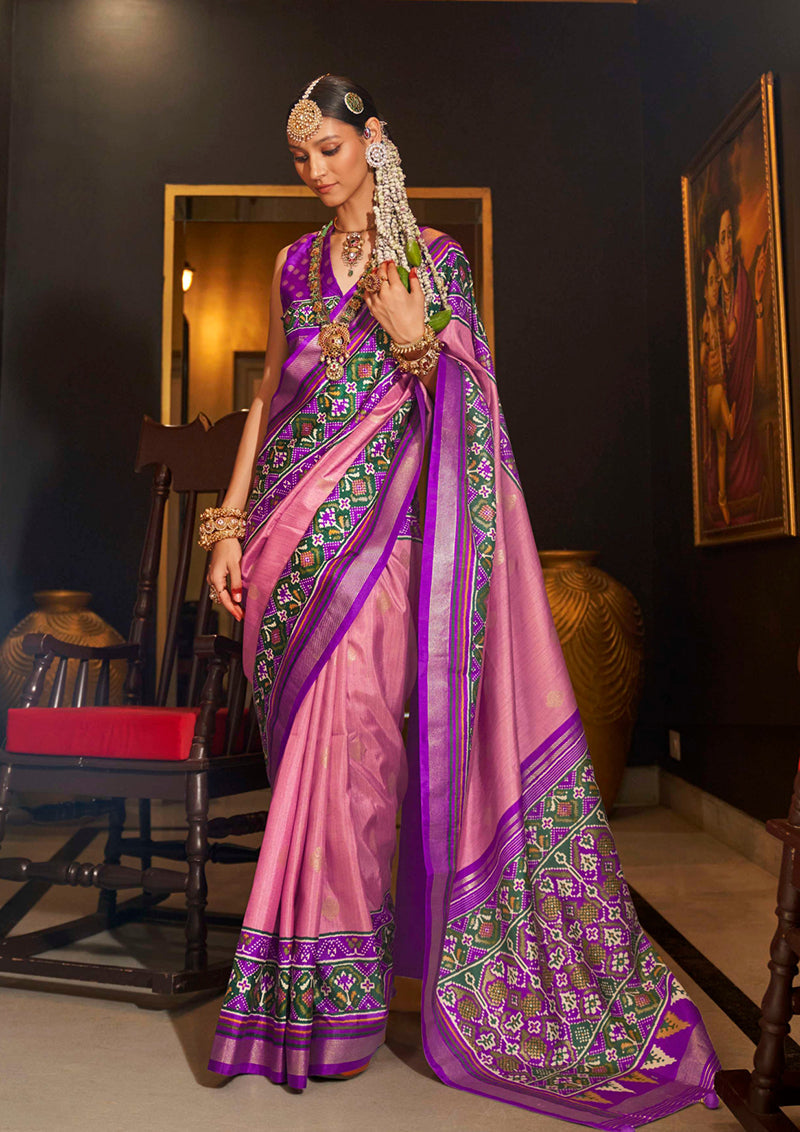 Light pink silk saree featuring traditional Patola print work