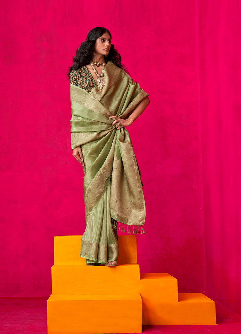 Exquisite green tissue silk traditional saree with elegant weaving detail.