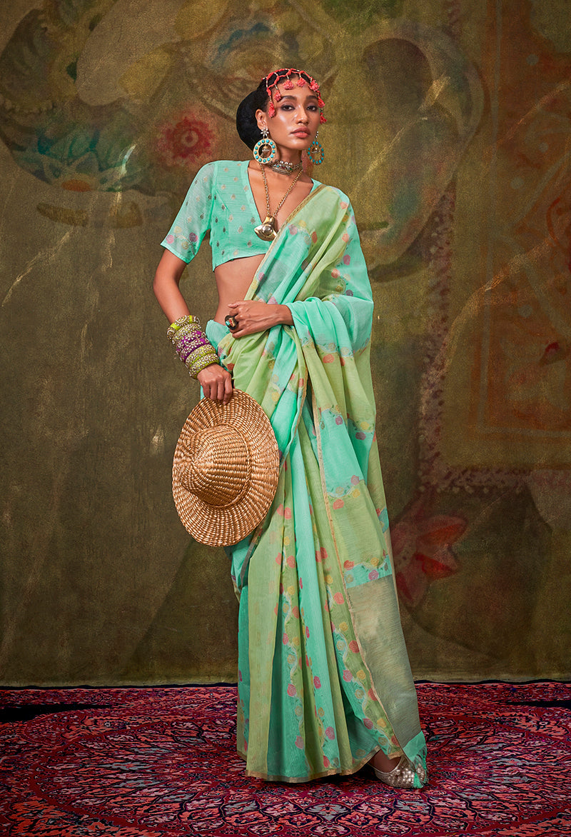 A stylish handloom cotton saree in green and turquoise with intricate weaving patterns.