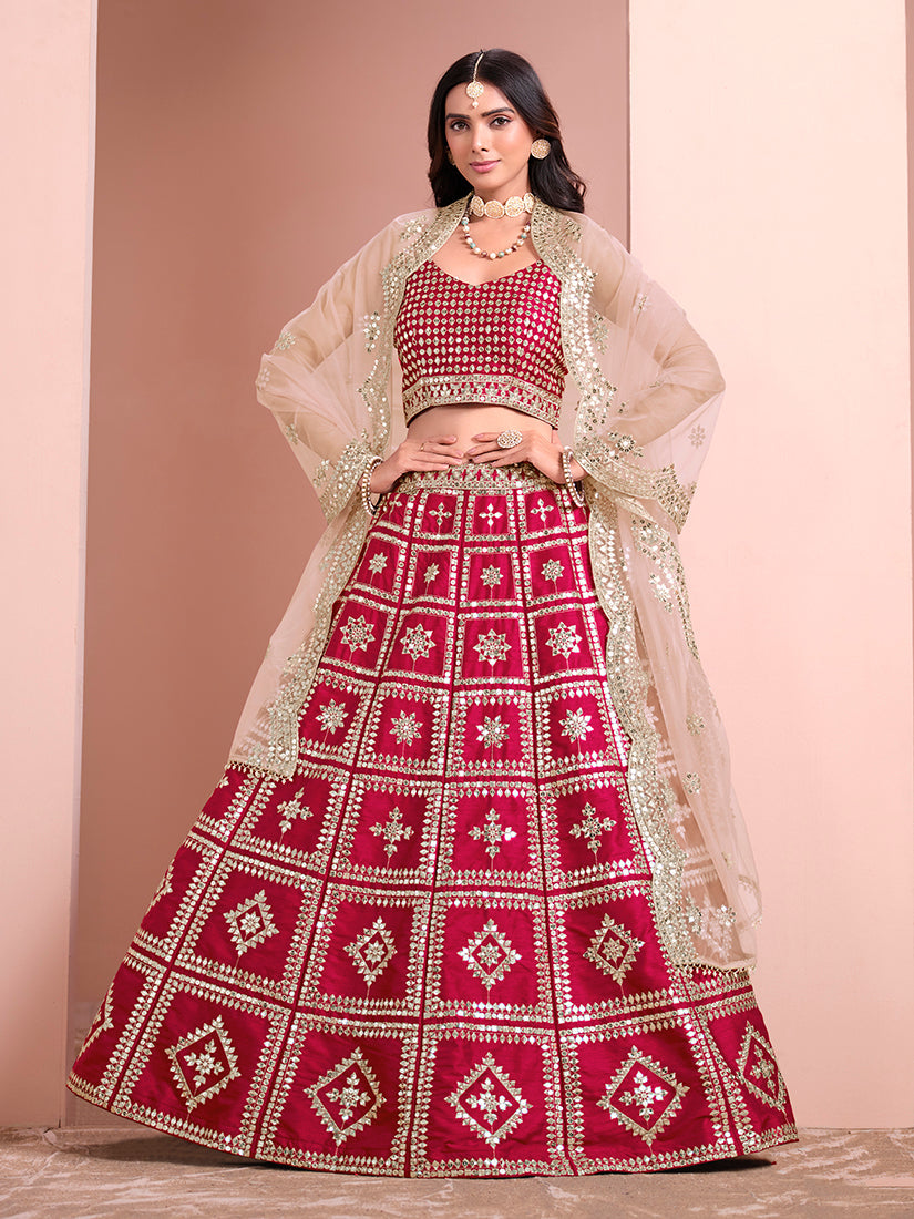 A front view of a rani-pink art silk A-line lehenga choli with geometric embroidery details.