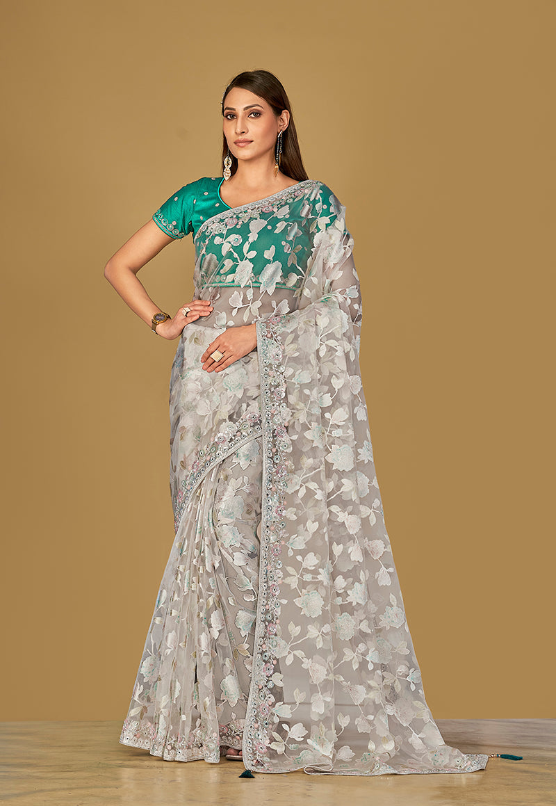 Off-white organza brasso saree featuring beautiful artistic prints.