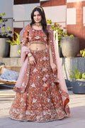 Dark orange art silk A-line lehenga choli with ornate embroidery.