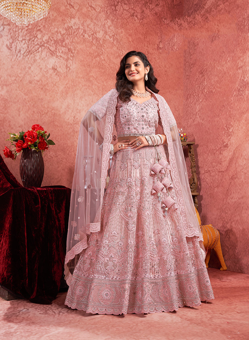 Pink net lehenga choli with intricate thread embroidery for festive occasions