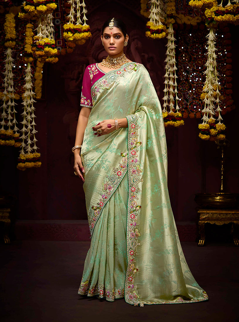 Sea green Kanjivaram silk saree with traditional beadwork and golden zari borders.
