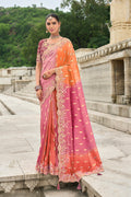 Pink and orange silk blend saree with traditional butti print details.