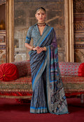 A blue silk blend contemporary saree with printed patterns draped elegantly.