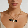 Natural shell initial pendant on a gold-plated chain, featuring coastal minimalist aesthetic