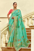 Sea green silk blend saree with traditional weave and Swarovski embellishments.